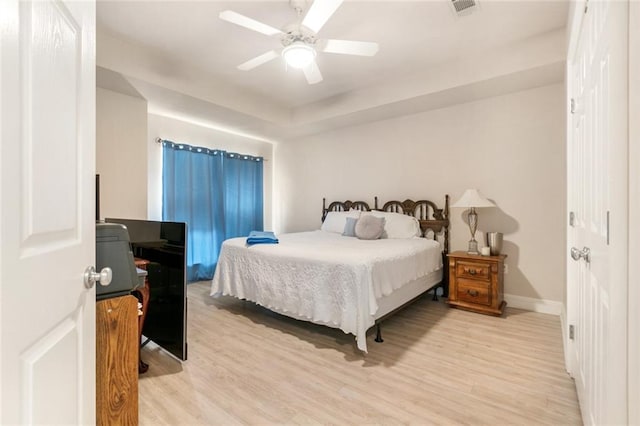 bedroom with light hardwood / wood-style floors and ceiling fan