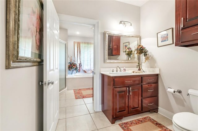 full bathroom featuring tile patterned flooring, vanity, shower with separate bathtub, and toilet