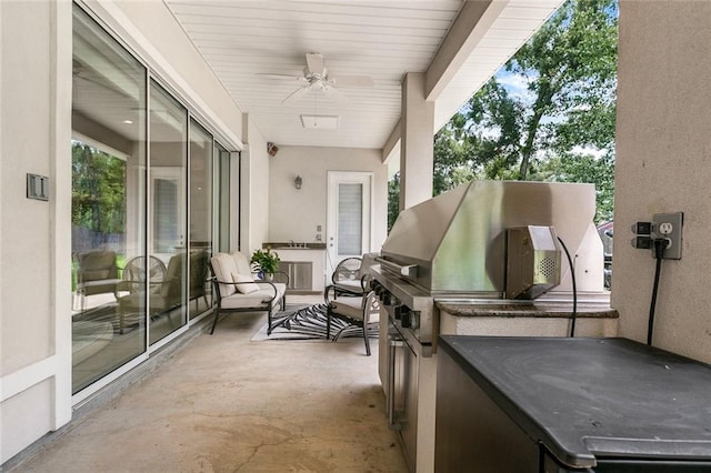 view of patio featuring grilling area, ceiling fan, and an outdoor kitchen