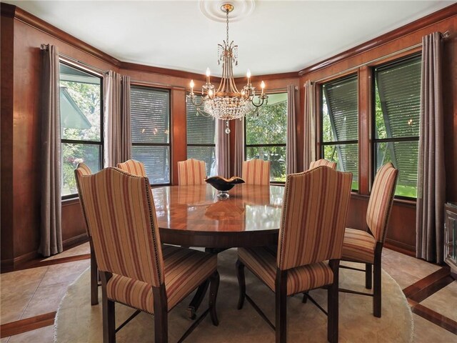 tiled dining room with an inviting chandelier