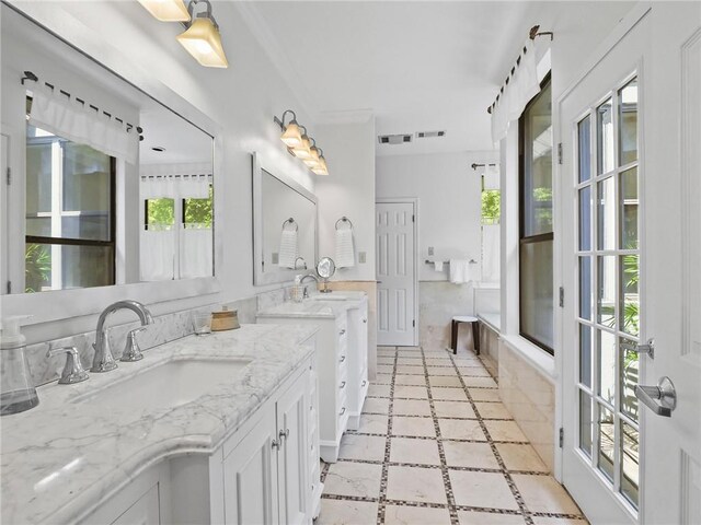 bathroom with crown molding, tile patterned flooring, and dual bowl vanity