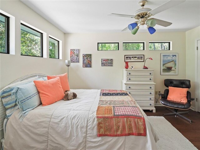 bedroom with ceiling fan and dark wood-type flooring