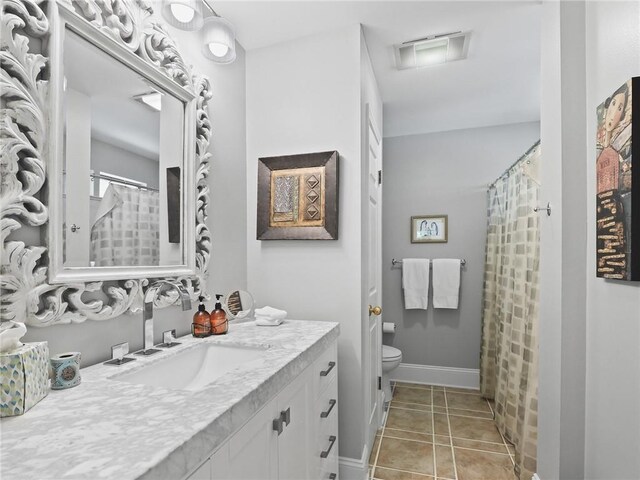 bathroom with tile patterned floors, toilet, and vanity