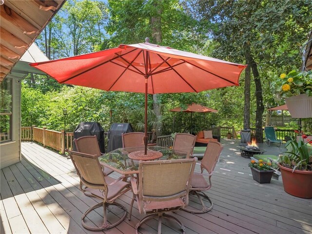 wooden deck featuring a fire pit