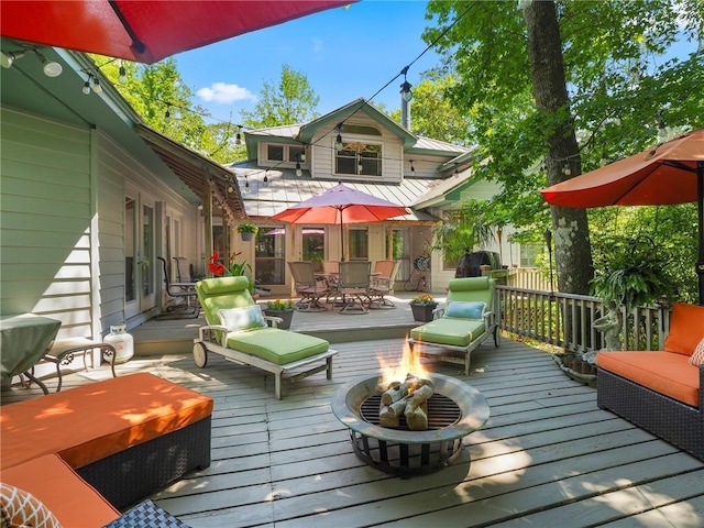 wooden deck featuring a fire pit