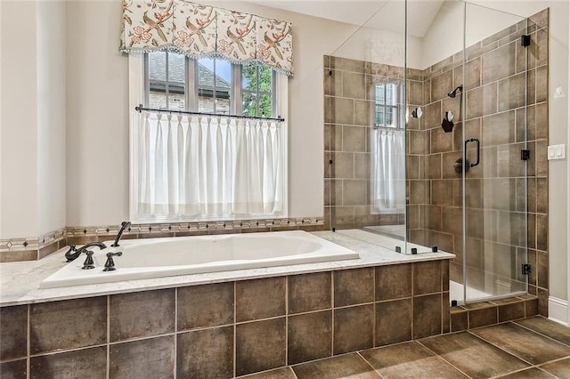 bathroom featuring shower with separate bathtub