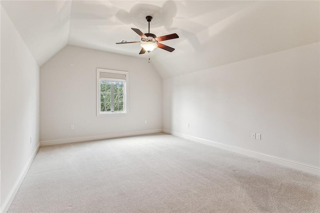 additional living space with lofted ceiling, light colored carpet, and ceiling fan