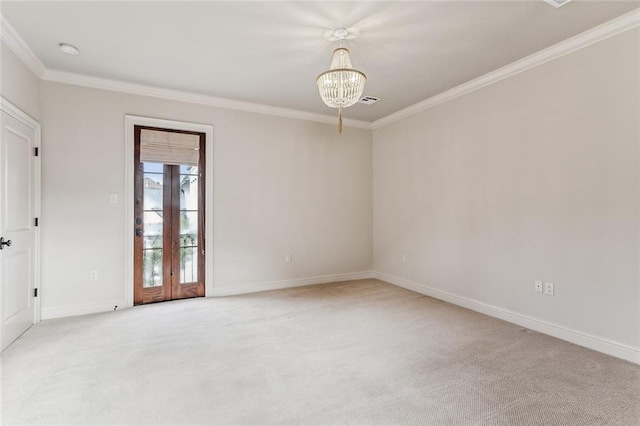 carpeted spare room with a notable chandelier and crown molding