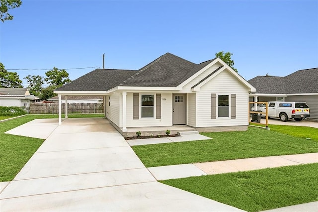 ranch-style house featuring driveway, roof with shingles, a front yard, and fence