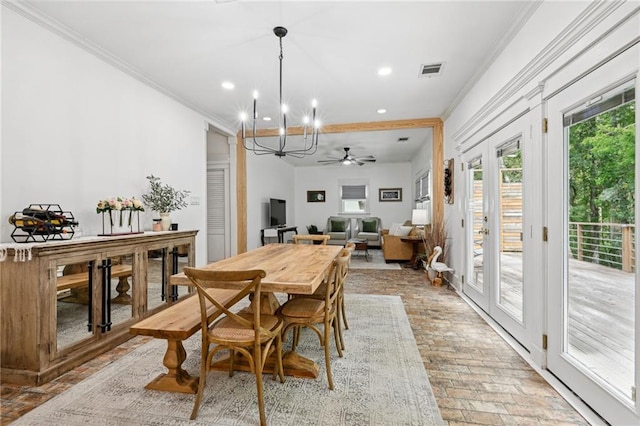 dining room with french doors, ceiling fan with notable chandelier, and ornamental molding