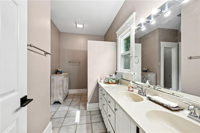 bathroom with double vanity and tile patterned floors