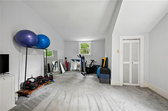 workout room with lofted ceiling and carpet