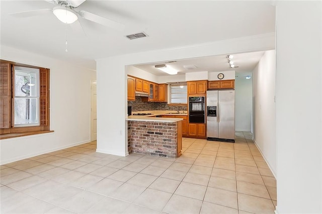 kitchen with stainless steel fridge with ice dispenser, tasteful backsplash, light tile patterned floors, ceiling fan, and double oven