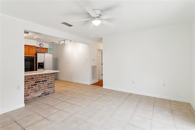 unfurnished living room featuring track lighting, light tile patterned floors, and ceiling fan