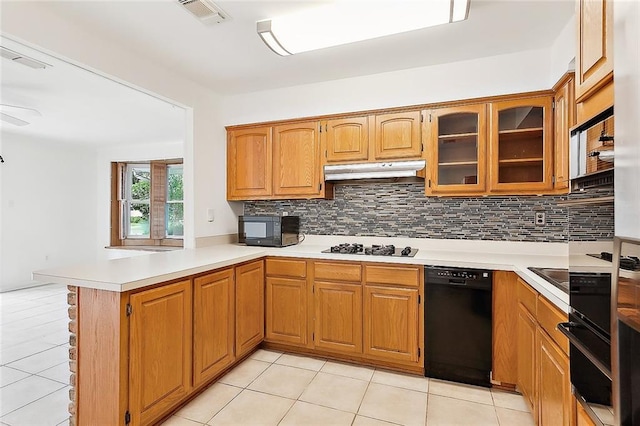 kitchen featuring light tile patterned floors, black appliances, and kitchen peninsula