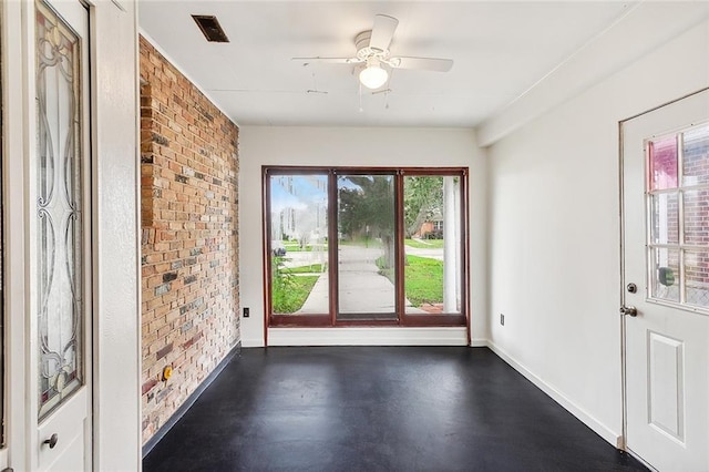 empty room with brick wall and ceiling fan