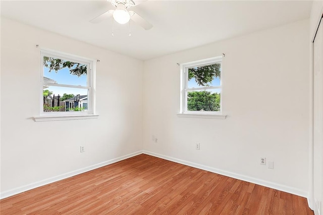 unfurnished room featuring ceiling fan and hardwood / wood-style flooring