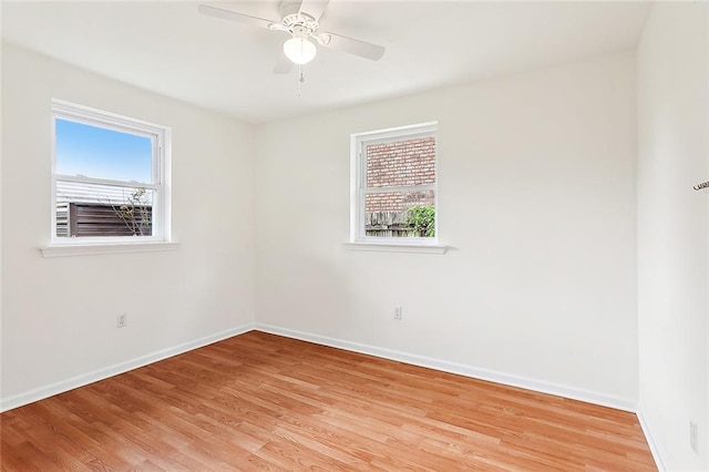 empty room with ceiling fan and light wood-type flooring