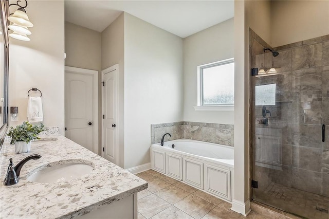 bathroom with independent shower and bath and vanity