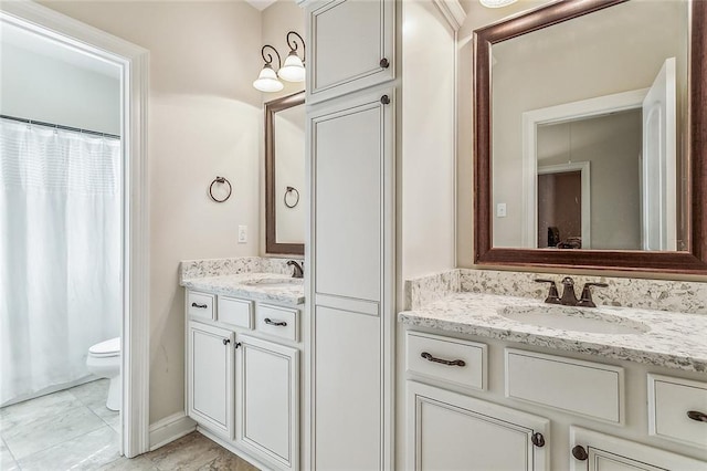 bathroom with tile patterned flooring, vanity, and toilet