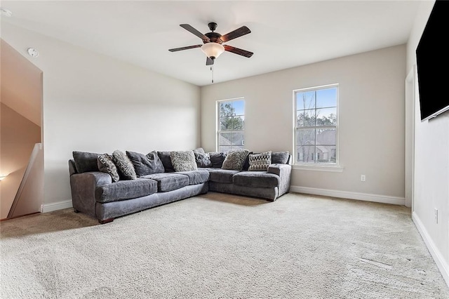 carpeted living room with ceiling fan