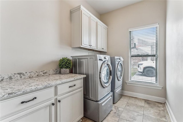 washroom featuring separate washer and dryer and cabinets