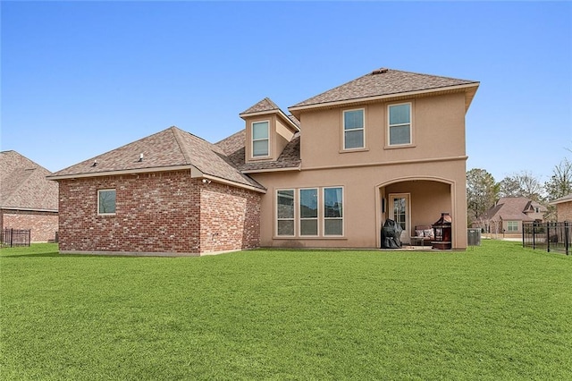 rear view of property featuring a lawn, cooling unit, and a patio area