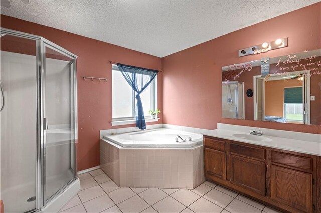 bathroom featuring vanity, a textured ceiling, tile patterned floors, and separate shower and tub