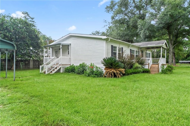 back of property featuring a yard and covered porch