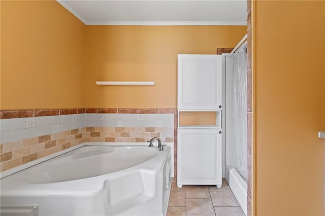 bathroom featuring tile patterned flooring, a tub to relax in, and crown molding