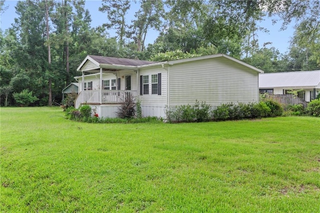 view of home's exterior featuring a porch and a yard