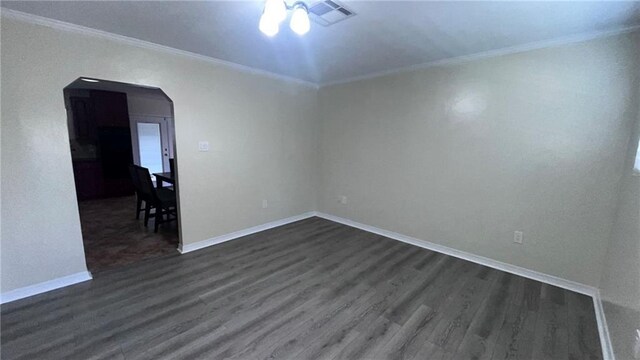 spare room featuring ceiling fan, hardwood / wood-style flooring, and crown molding