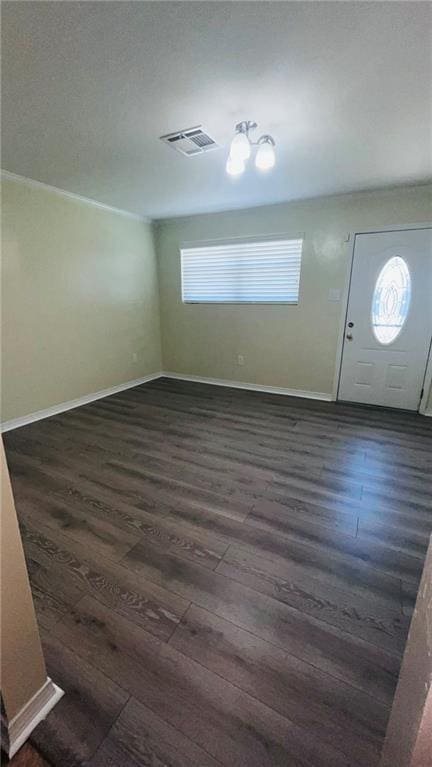 foyer featuring dark wood-type flooring, visible vents, and baseboards