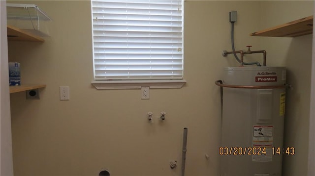 laundry area featuring water heater, laundry area, and electric dryer hookup