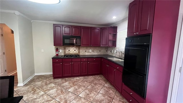 kitchen with tasteful backsplash, arched walkways, dark countertops, black appliances, and a sink