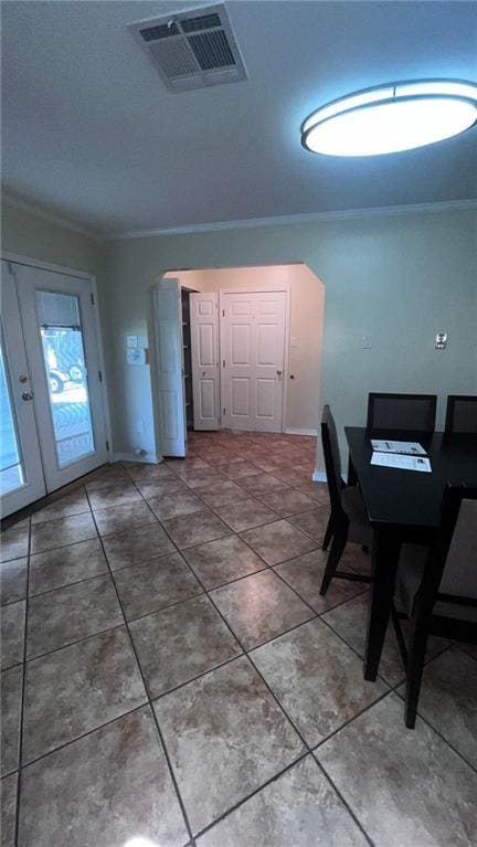 tiled home office featuring visible vents, crown molding, and french doors