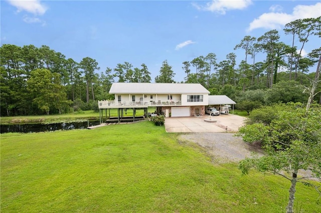 view of front facade with a water view, a garage, and a front lawn