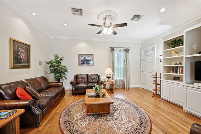 living room with light wood-type flooring, ceiling fan, and ornamental molding