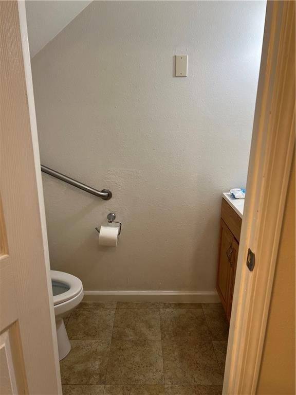 bathroom featuring vanity, tile patterned flooring, and toilet