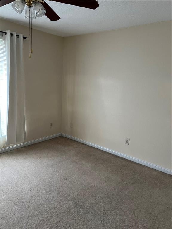 carpeted empty room with ceiling fan