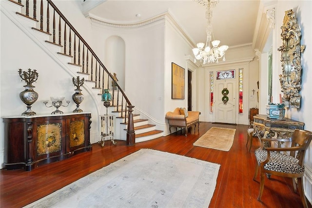 2027 Carondelet St, New Orleans, LA 70130 - entryway featuring hardwood / wood-style flooring, a chandelier, stairway, and crown molding