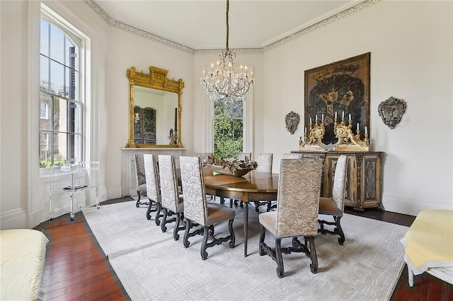 2027 Carondelet St, New Orleans, LA 70130 - dining room featuring wood-type flooring, ornamental molding, a healthy amount of sunlight, and an inviting chandelier