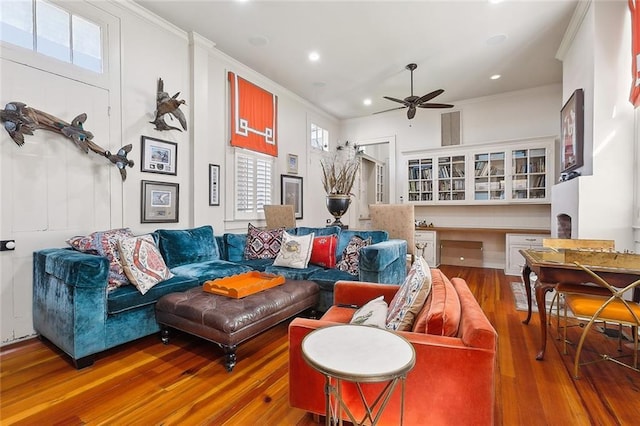 2027 Carondelet St, New Orleans, LA 70130 - living room featuring wood-type flooring, ornamental molding, built in desk, and ceiling fan