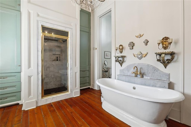 2027 Carondelet St, New Orleans, LA 70130 - bathroom with shower with separate bathtub and wood-type flooring