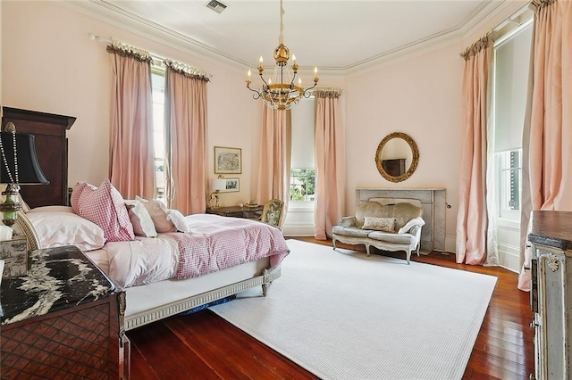 2027 Carondelet St, New Orleans, LA 70130 - bedroom with a notable chandelier, crown molding, and dark wood-type flooring