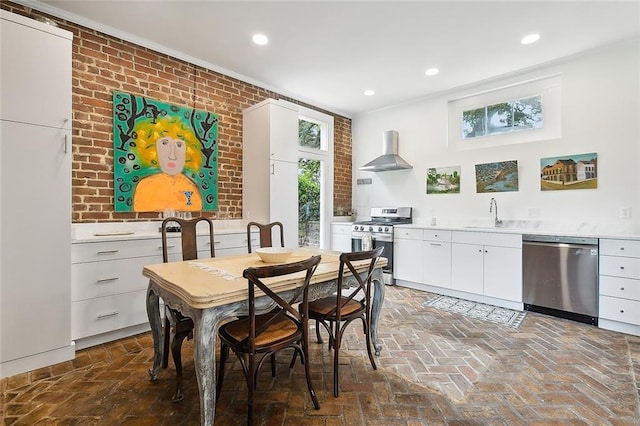 2027 Carondelet St, New Orleans, LA 70130 - dining space with brick wall, sink, and a wealth of natural light