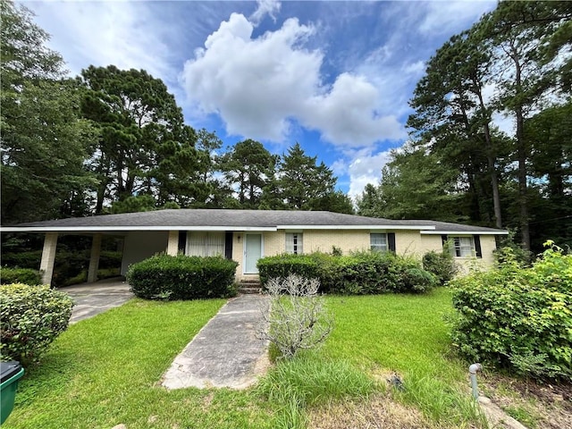 ranch-style home featuring a carport and a front yard