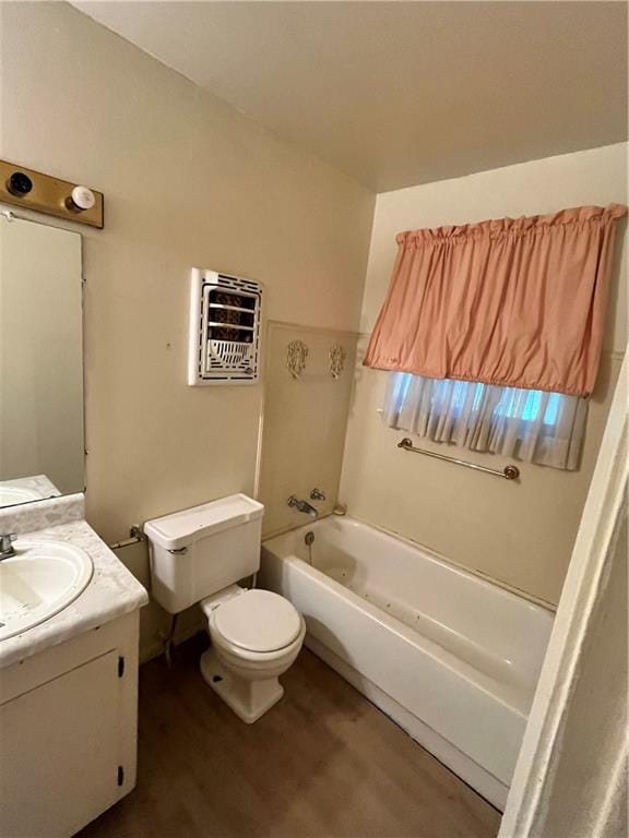 full bathroom with vanity, hardwood / wood-style floors,  shower combination, and toilet