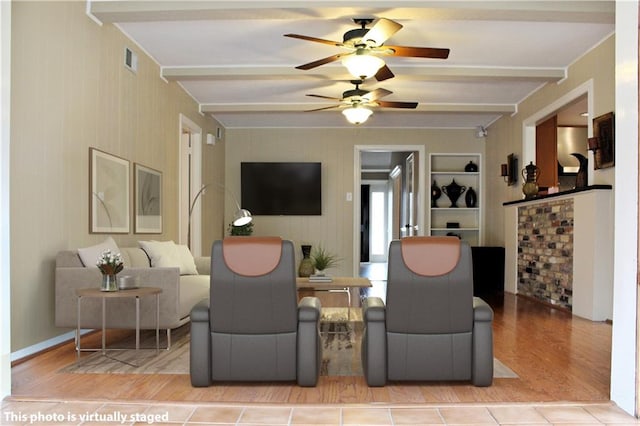 living room featuring beam ceiling, light wood-type flooring, and ceiling fan