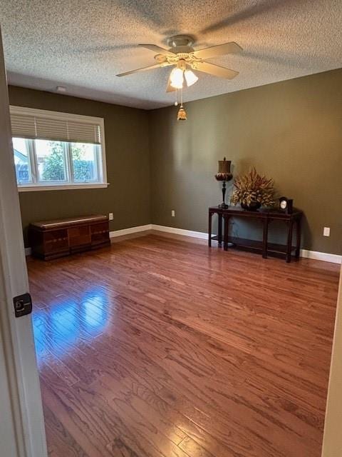 unfurnished room featuring ceiling fan, a textured ceiling, and hardwood / wood-style floors